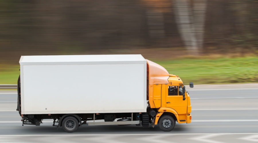 Yellow heavy truck driving on the highway