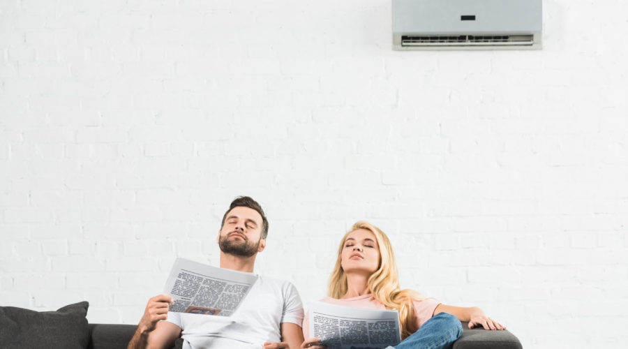 How Does a Hurricane Impact Your Heating and Cooling Systems? 1 couple on couch with newspapers suffering from hea 2021 09 03 01 40 19 utc scaled