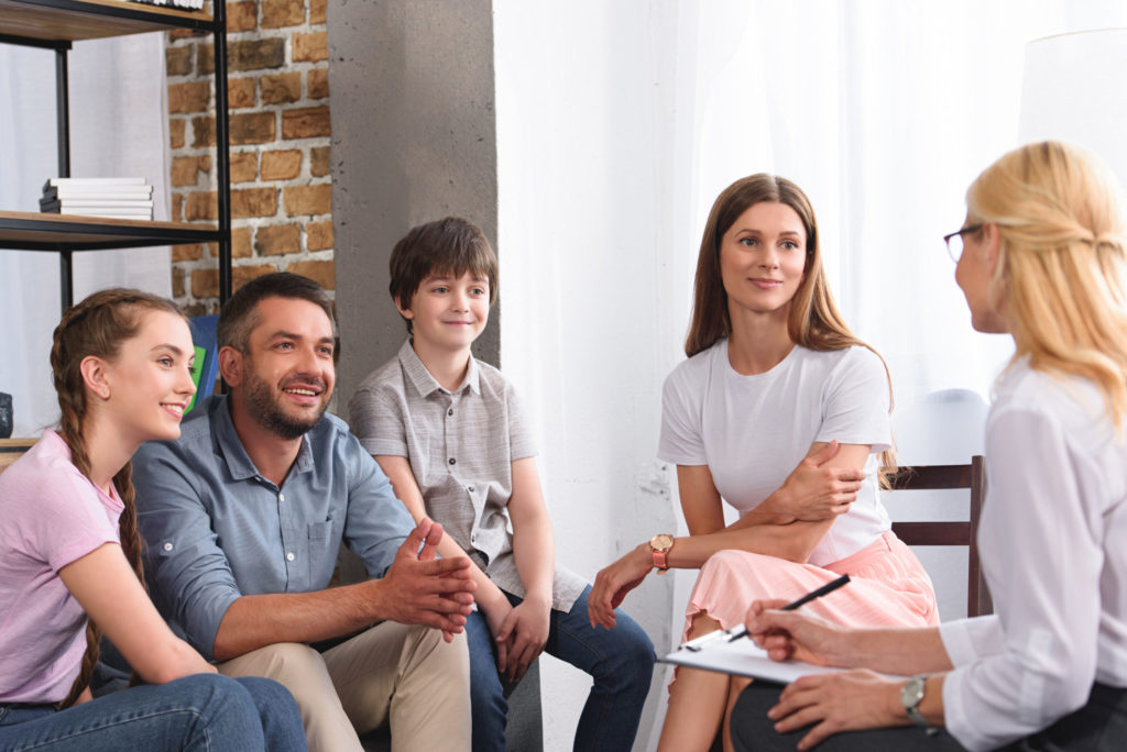 happy family sitting on therapy session by female 2021 08 29 22 51 23 utc scaled