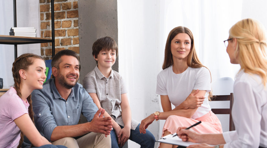 3 Family Services That You May Need 4 happy family sitting on therapy session by female 2021 08 29 22 51 23 utc scaled