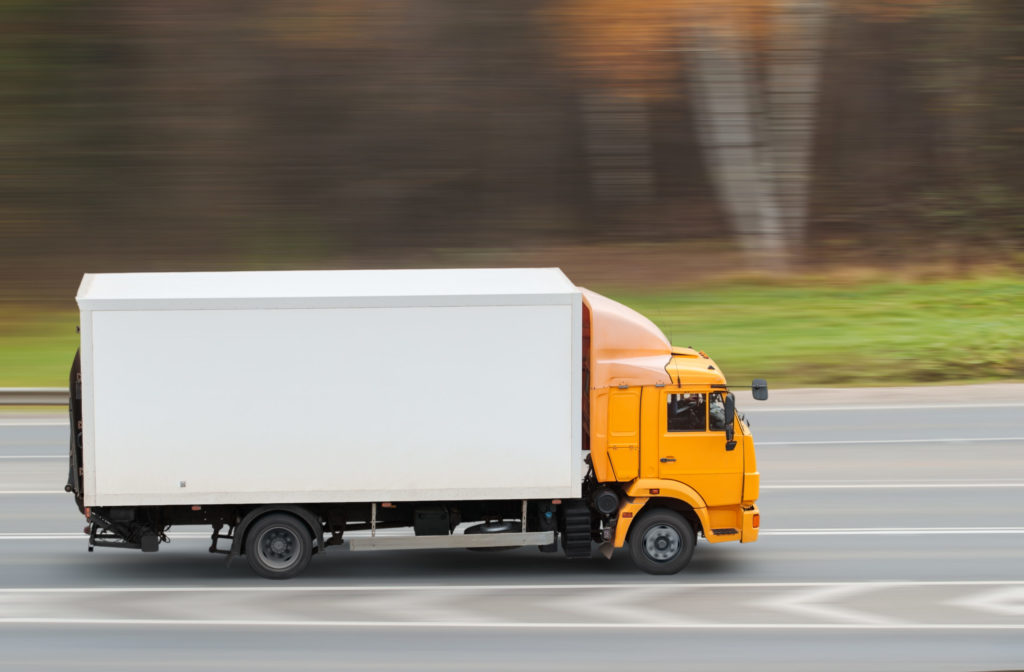 Yellow heavy truck driving on the highway