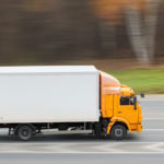 Yellow heavy truck driving on the highway