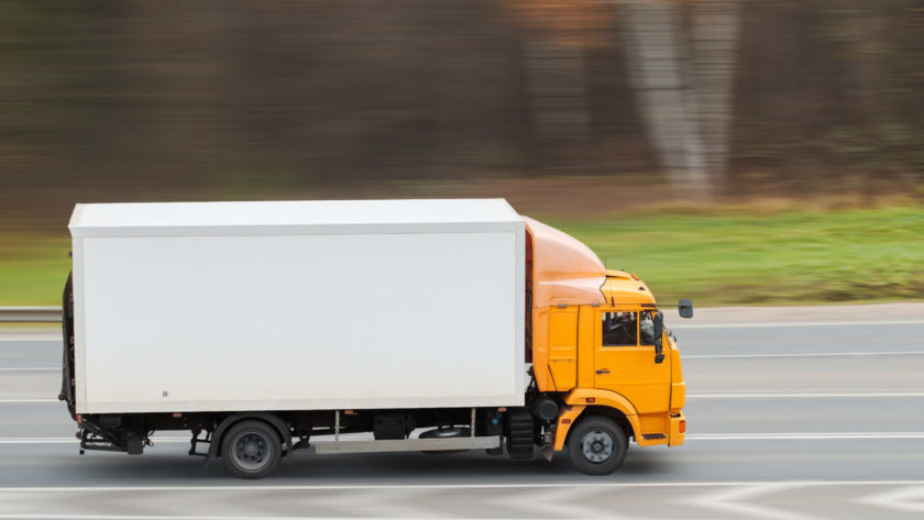 Yellow heavy truck driving on the highway