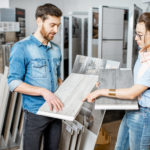 Couple choosing ceramic tiles in the shop