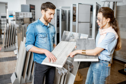 Couple choosing ceramic tiles in the shop