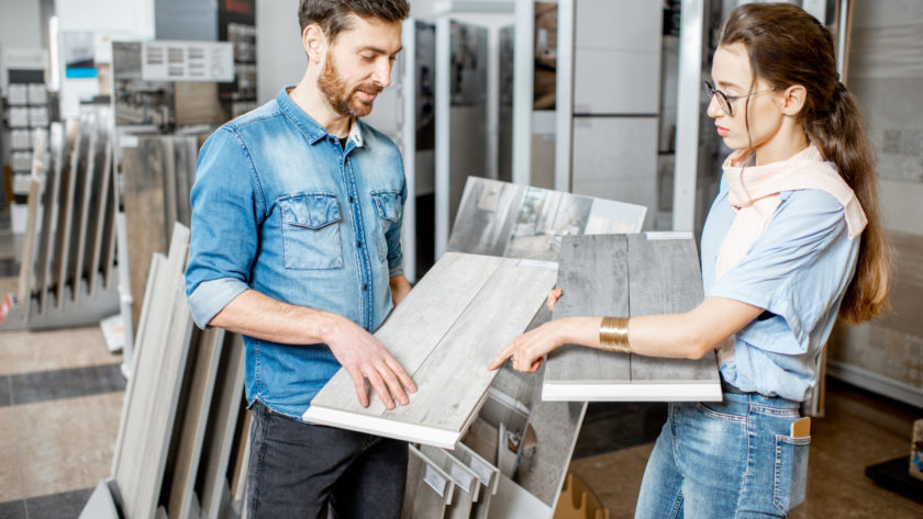 Couple choosing ceramic tiles in the shop