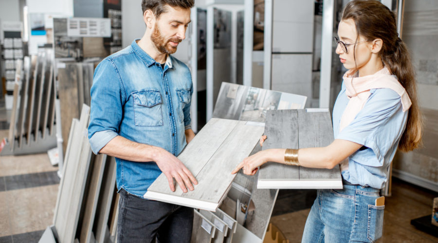 Couple choosing ceramic tiles in the shop