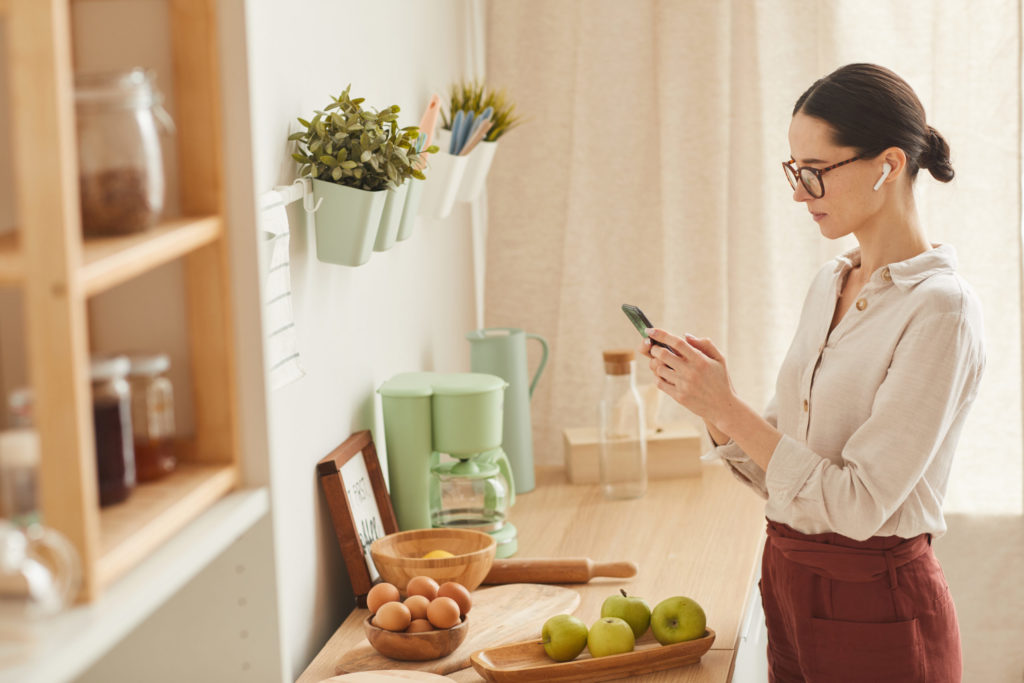 Elegant Woman Using Smartphone at Home