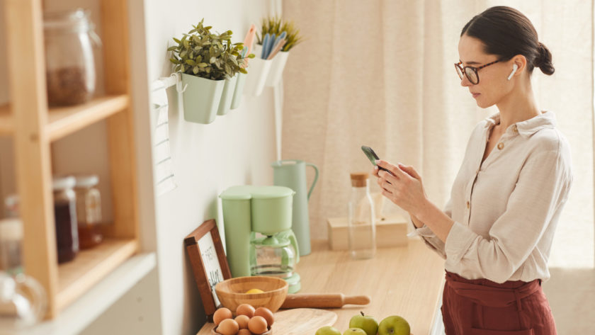 Elegant Woman Using Smartphone at Home