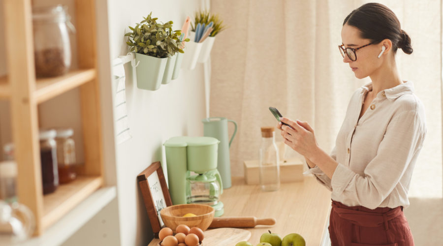 Tips for Redecorating Your Home 1 Elegant Woman Using Smartphone at Home