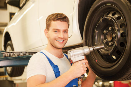 Removing tires from car.