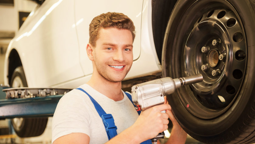 Removing tires from car.