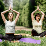 young and elder woman doing yoga in the park 2021 12 11 01 36 37 utc scaled