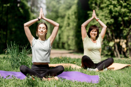 young and elder woman doing yoga in the park 2021 12 11 01 36 37 utc scaled