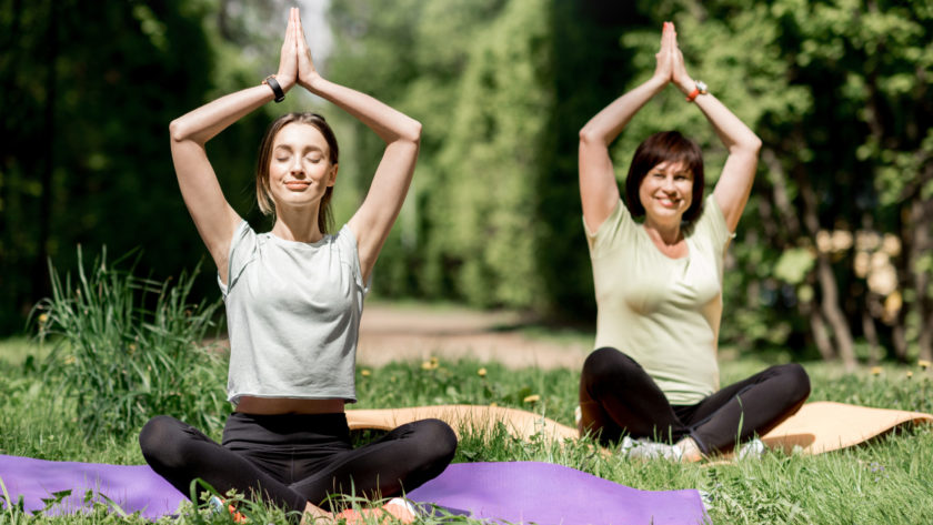 young and elder woman doing yoga in the park 2021 12 11 01 36 37 utc scaled