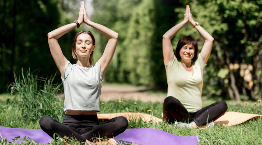 young and elder woman doing yoga in the park 2021 12 11 01 36 37 utc scaled