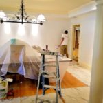 Painters paint a room during a remodel