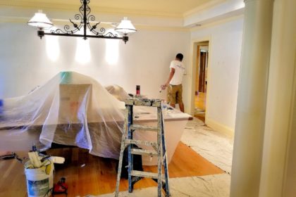 Painters paint a room during a remodel