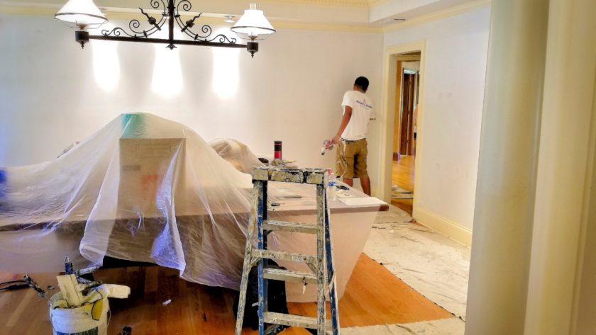 Painters paint a room during a remodel