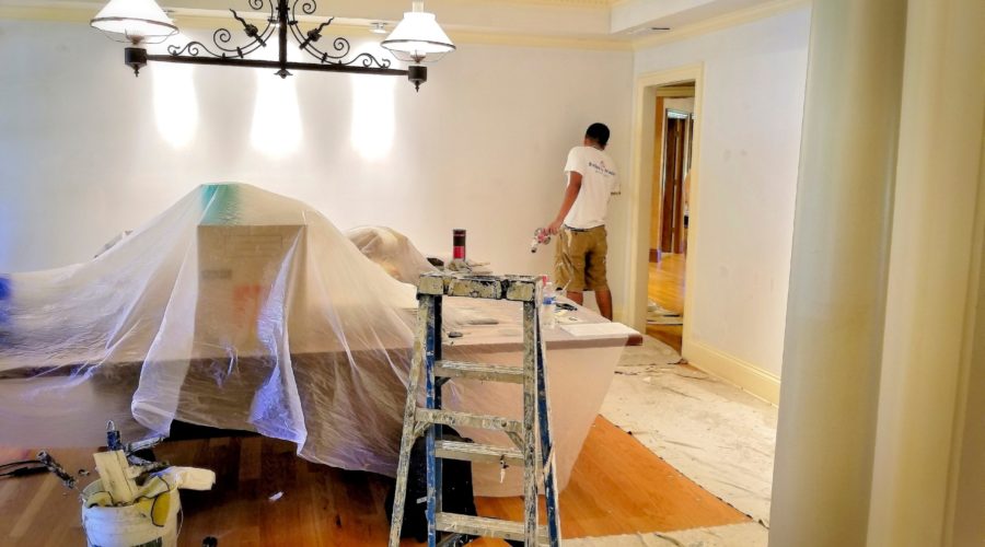 Painters paint a room during a remodel