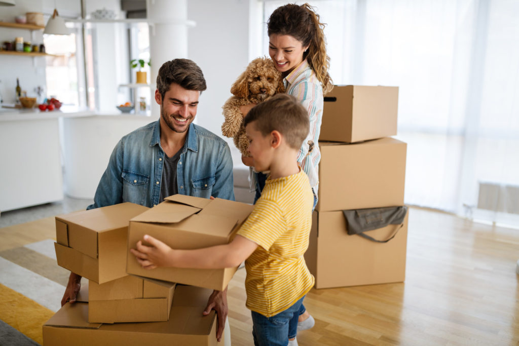 family unpacking cardboard boxes at new home 2021 09 02 07 57 46 utc scaled