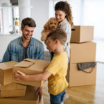 family unpacking cardboard boxes at new home 2021 09 02 07 57 46 utc scaled