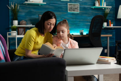 mother sitting beside daughter holding school book 2022 01 19 00 22 42 utc scaled