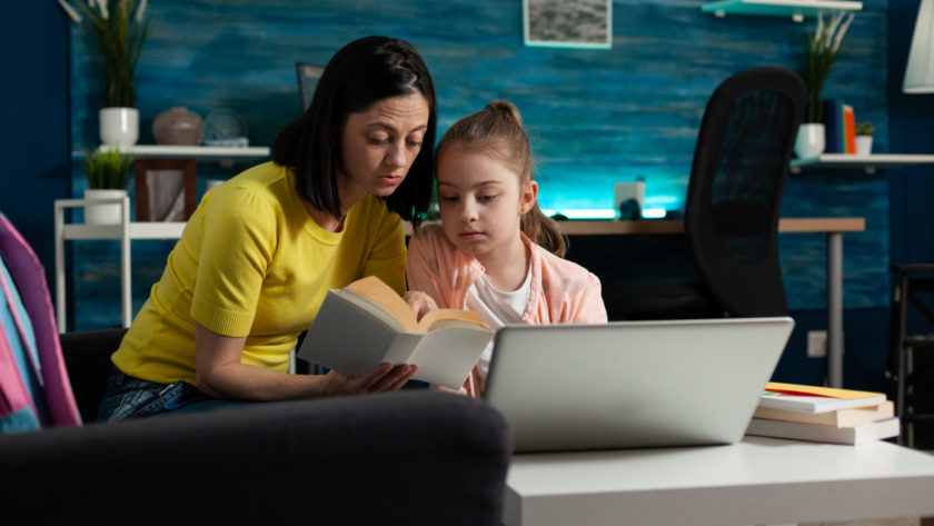 mother sitting beside daughter holding school book 2022 01 19 00 22 42 utc scaled