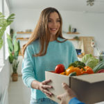 happy young woman accepting box with groceries fro 2022 10 28 05 39 38 utc