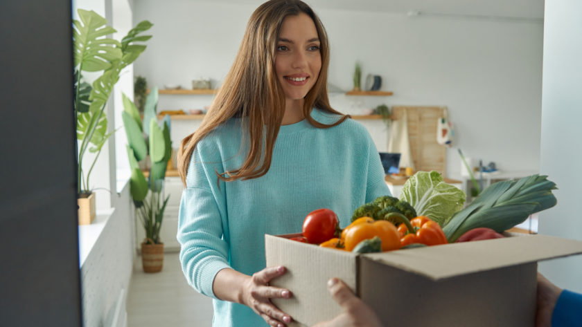 happy young woman accepting box with groceries fro 2022 10 28 05 39 38 utc