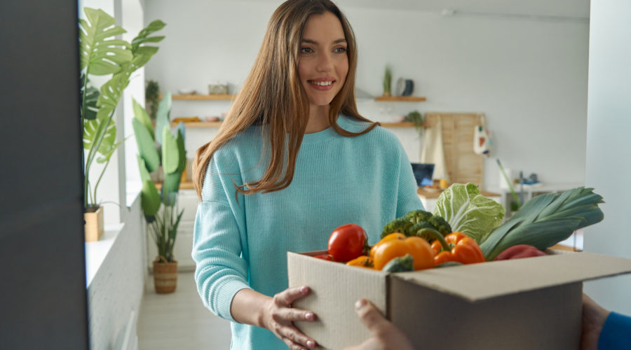 happy young woman accepting box with groceries fro 2022 10 28 05 39 38 utc