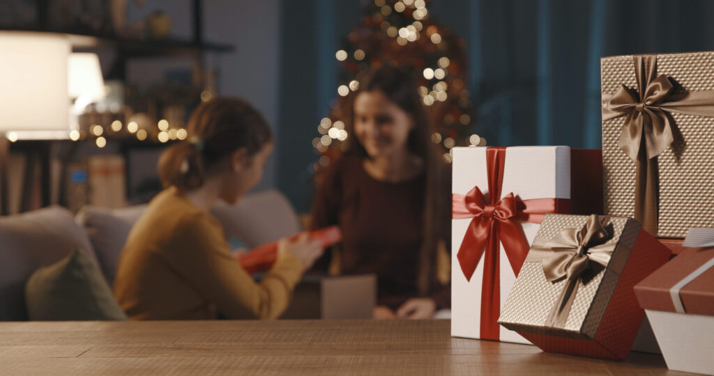 mother and daughter exchanging christmas gifts 2022 01 19 00 21 44 utc scaled