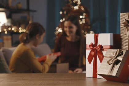 mother and daughter exchanging christmas gifts 2022 01 19 00 21 44 utc scaled