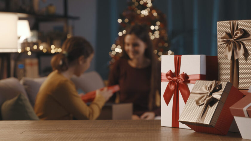 mother and daughter exchanging christmas gifts 2022 01 19 00 21 44 utc scaled